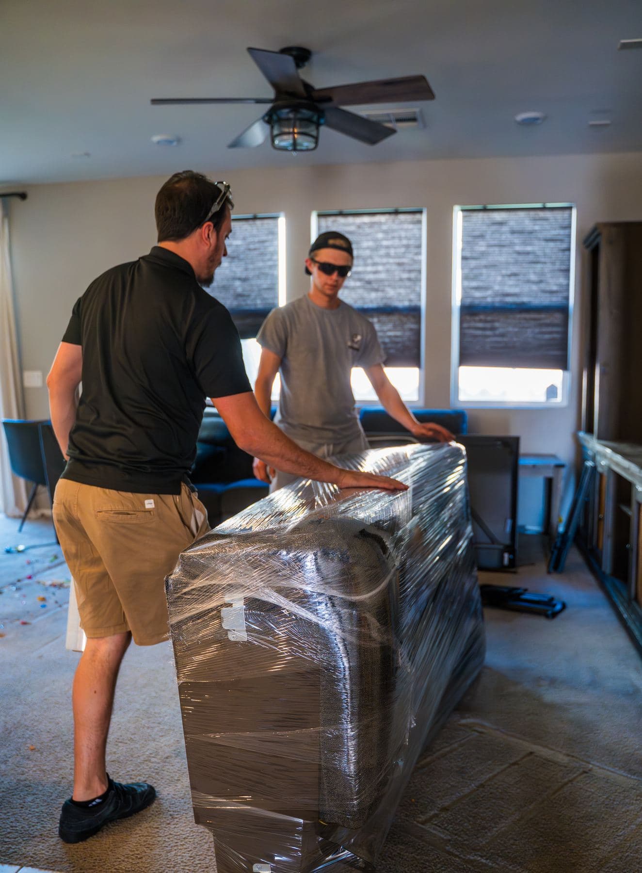 Coyotes Moving crew members wrapping furniture during a move in Silverado Ranch, Nevada