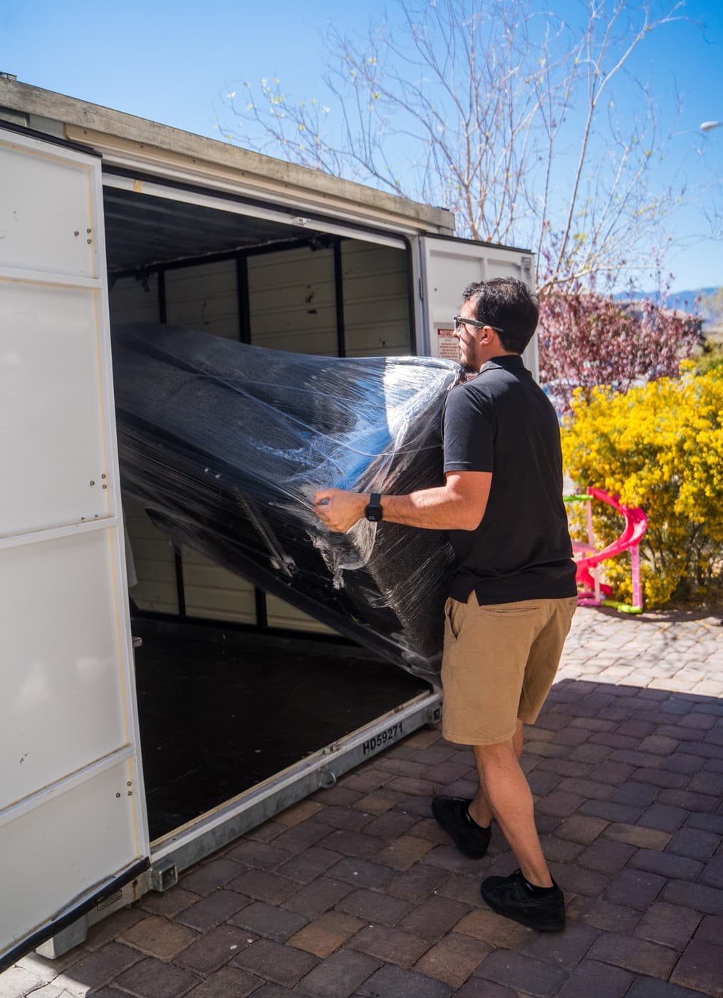 Coyotes Moving crew loading furniture into a truck outside a single-family home in the Silverado Ranch area