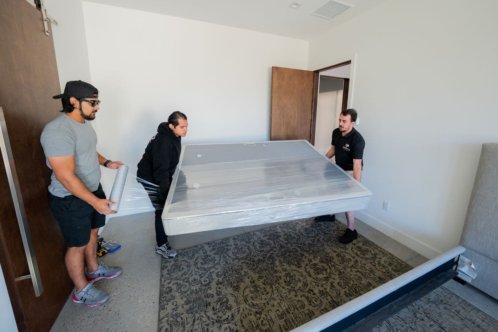 Coyotes Moving crew members carrying furniture for a Spring Valley move