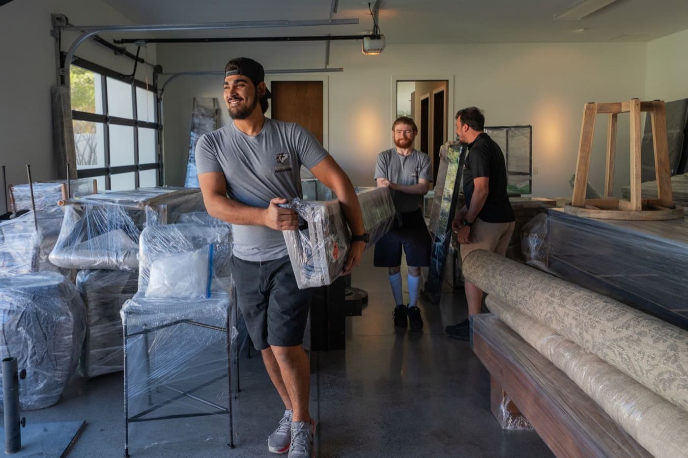 Coyotes Moving crew members carrying furniture for a Summerlin move