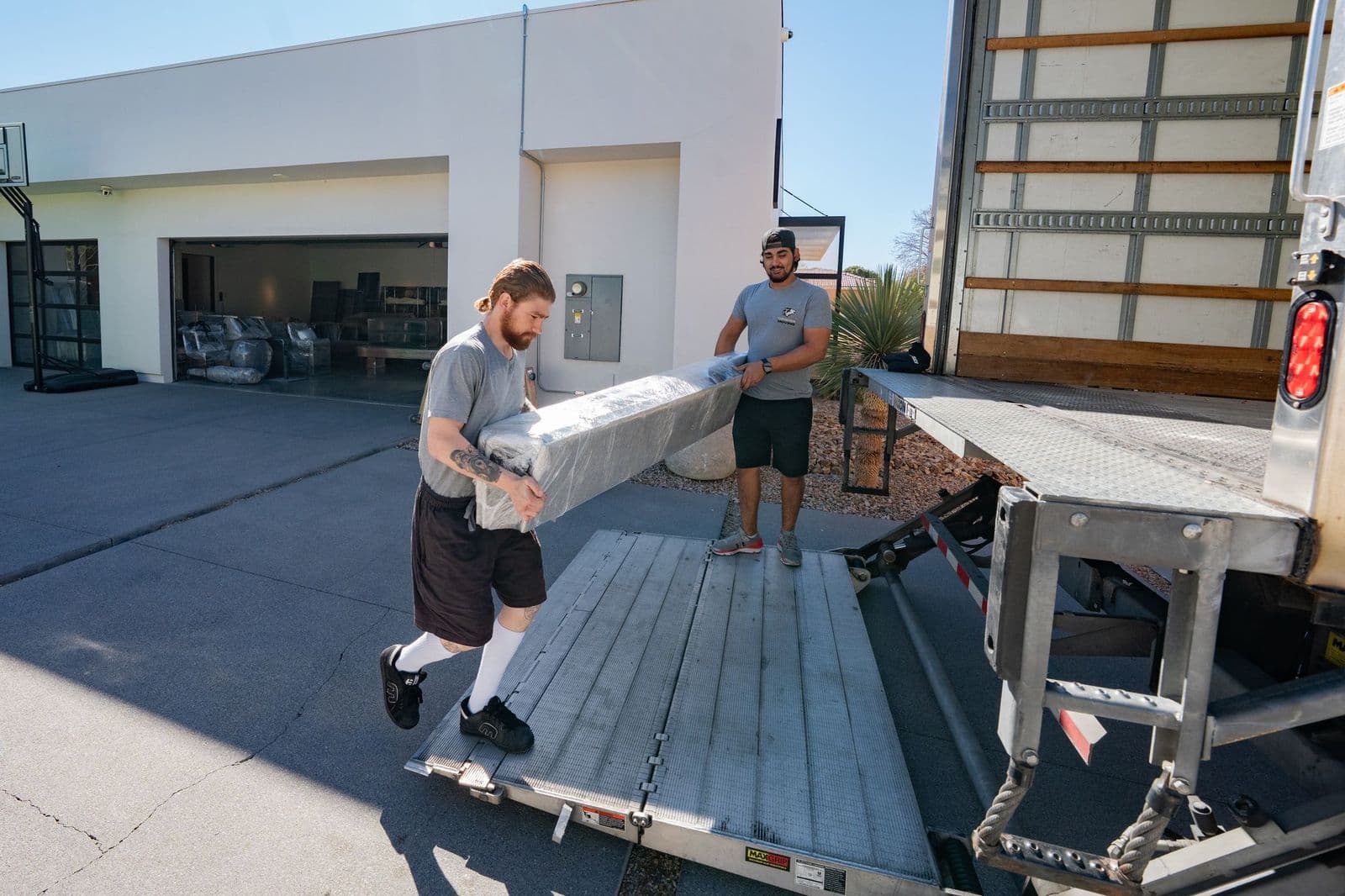 Coyotes Moving crew hauling junk out for same-day removal